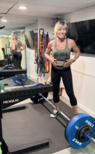 Polli standing with loaded bar in weight belt