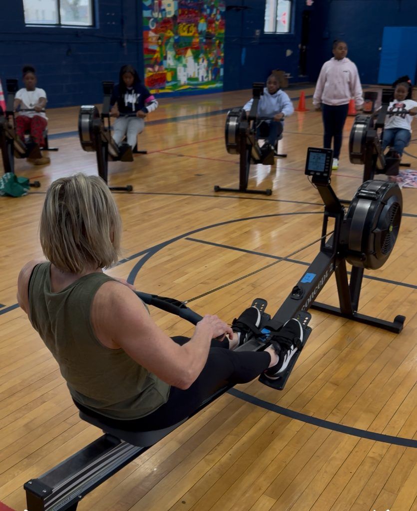 Polli rowing with kids from the back