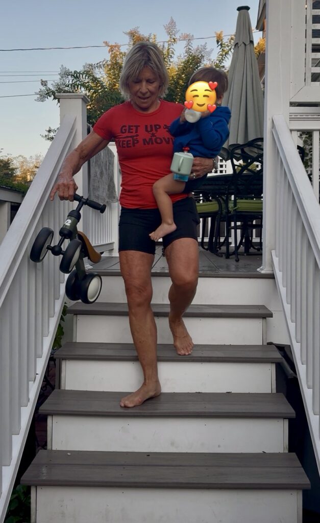 Polli going down deck stairs with Logan 1