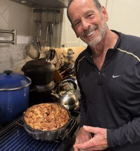 Michael with apple cake in pan
