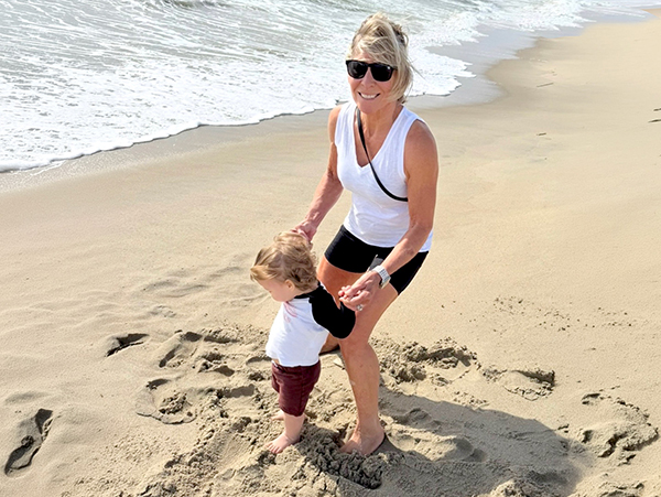 Polli on the beach with her grandson